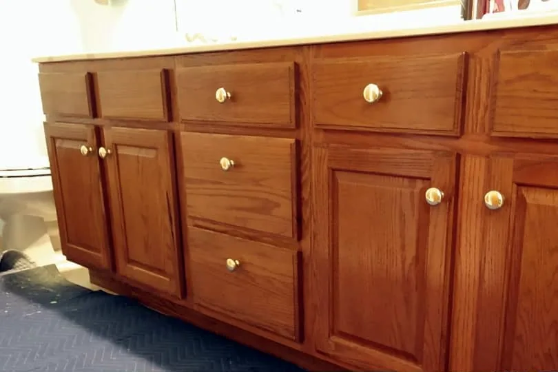 Before: dated oak vanity cabinets